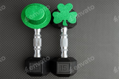 Preview: Pair Of 15-Pound Dumbbells On A Black Gym Floor, Green Leprechaun Hat, Green Shamrock