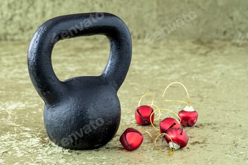 Preview: Black Kettlebell On A Green Velvet Background With Red Jingle Bells On Gold Thread, Holiday Fitness