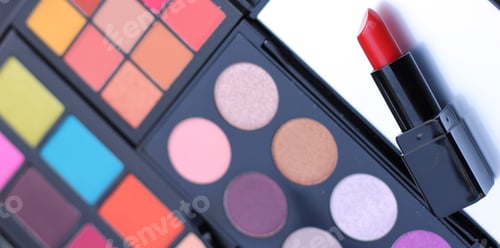 Preview: Red Lipstick With Colorful Cosmetic Palettes In Background
