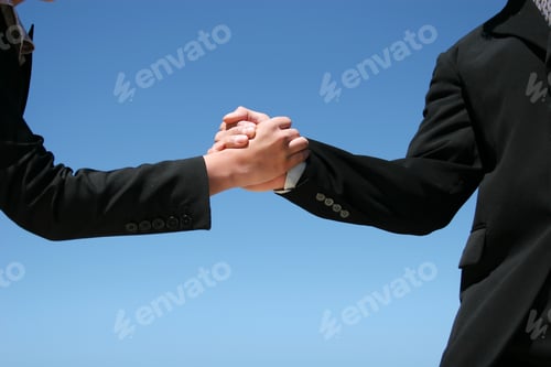 Preview: Businessman And Businesswoman Handshaking For Agreement