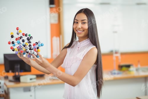 Preview: Portrait Of Happy Schoolgirl Experimenting Molecule Model In Laboratory At School
