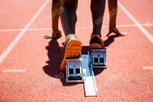 Preview: Close-Up Of Feet Of An Athlete On A Starting Block About To Run