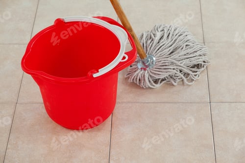 Preview: Close-Up Of Empty Bucket And Mop On Tile Floor