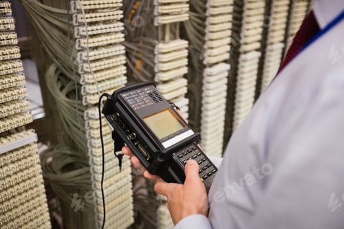 Preview: Technician Using Digital Cable Analyzer In Server Room