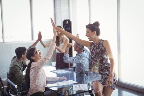 Preview: Happy Business Colleages Giving High Five At Creative Office Desk