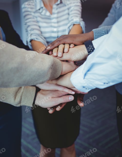 Preview: Business Colleagues Stacking Hands At Office