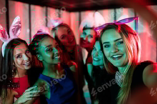 Preview: Group Of Smiling Friends Posing For Selfie In Bar