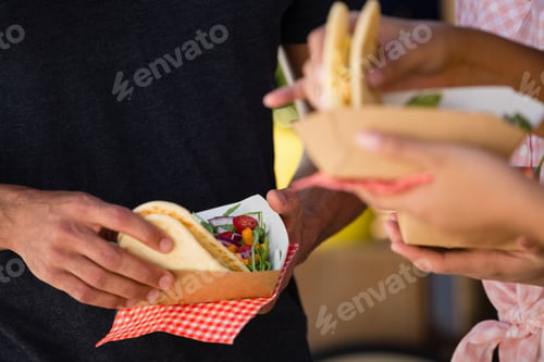 Preview: Cropped Hands Of Friends Holding Tortilla
