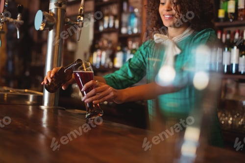 Preview: Waitress Pouring Beer In Pilsner Glass At Counter In Pub