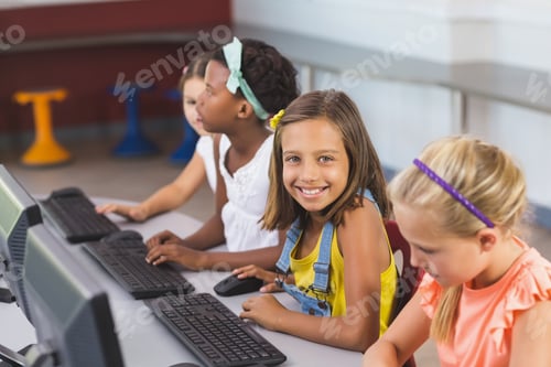 Preview: Schoolgirls Using Computer In Classroom At School