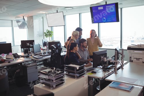 Preview: Business People Working Together At Desk In Office