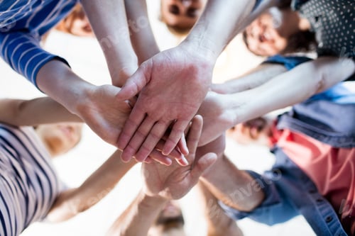 Preview: Creative Business Team Stacking Hands Together In Office