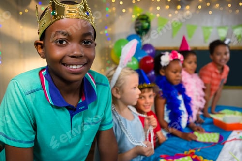 Preview: Portrait Of Boy Wearing Crown With Friends In Background During Party
