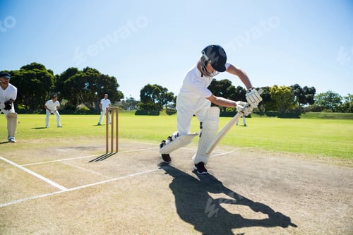 Preview: Young Man Playing Cricket At Field Against Clear Sky On Sunny Day