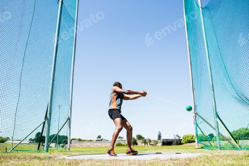 Preview: Athlete Performing A Hammer Throw In Stadium