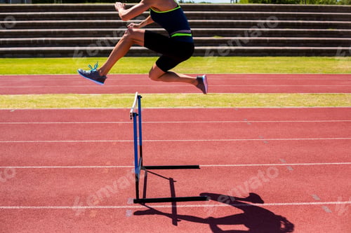 Preview: Female Athlete Jumping Above The Hurdle During The Race