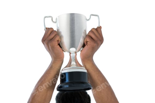 Preview: Hand Of Businessman Lifting A Trophy Against White Background
