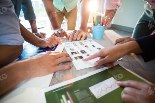 Preview: Close-Up Of Business People Discussing Over Graph During A Meeting In The Office