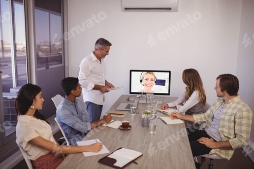 Preview: Focused Business People Looking At Screen During Video Conference In Office