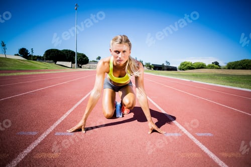 Preview: Female Athlete Ready To Run On Running Track On A Sunny Day