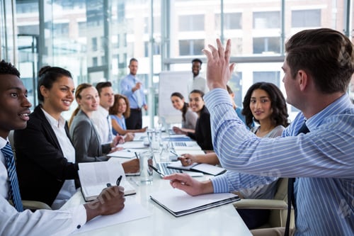 Preview: Colleague Raising His Hand During Meeting In Office