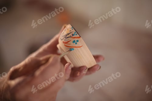 Preview: Close-Up Of Potter Painting On Bowl In Pottery Workshop