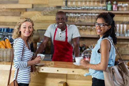 Preview: Waiter Serving Coffee To Female Customer In Cafã©