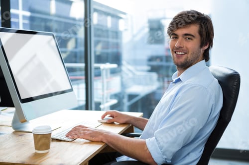 Preview: Portrait Of Businessman Working At Desk In Office