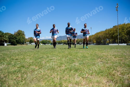 Preview: Confident Rugby Team Running At Field On Sunny Day