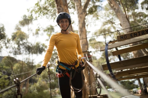 Preview: Portrait Of Happy Woman On Zipline In Adventure Park