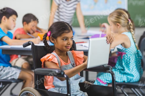 Preview: Disabled Schoolgirl Using Digital Tablet In Classroom At School
