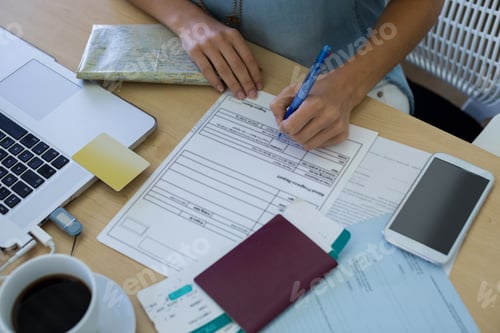 Preview: Close-Up Of Female Executive Filling Form At Her Desk In Office
