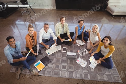 Preview: Portrait Of Creative Business Team Sitting On Floor In Office