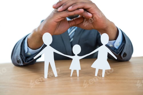 Preview: Close-Up Of Businessman Protecting Paper Cut Out Family With Hands