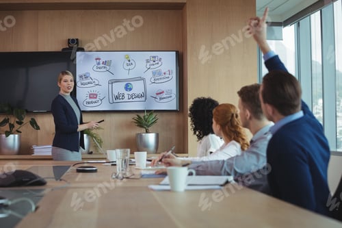 Preview: Businesswoman Interacting With Team During Meeting At Conference Table In Board Room