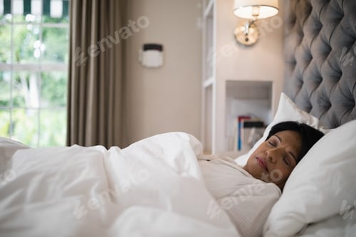 Preview: Tired Mature Woman Sleeping On Bed At Home