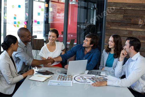 Preview: Male Graphic Designer Shaking Hands With His Colleague In Office