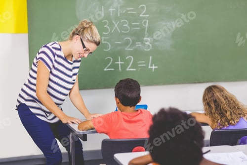 Preview: Teacher Teaching Mathematics To School Kids In Classroom At School