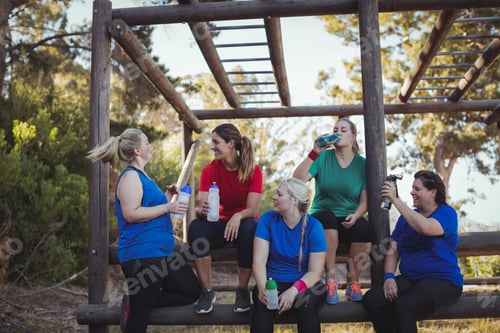 Preview: Group Of Women Drinking Water In The Boot Camp On A Sunny Day
