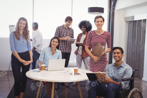 Preview: Portrait Of Smiling Business Team With Handicap Colleague In Creative Office