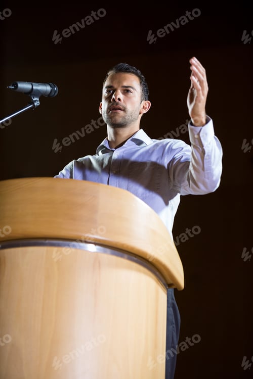 Preview: Business Executive Giving A Speech At Conference Center