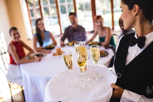 Preview: Close-Up Of Waitress Champagne Glasses On Tray In Restaurant