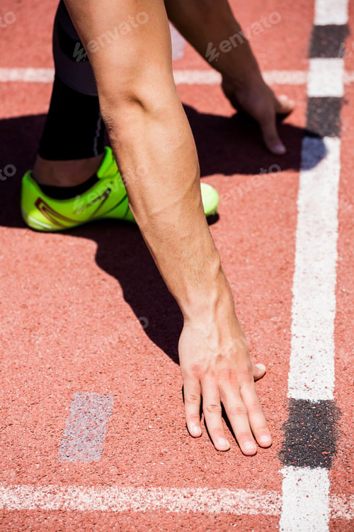 Preview: Athletes Hands On A Starting Block About To Run