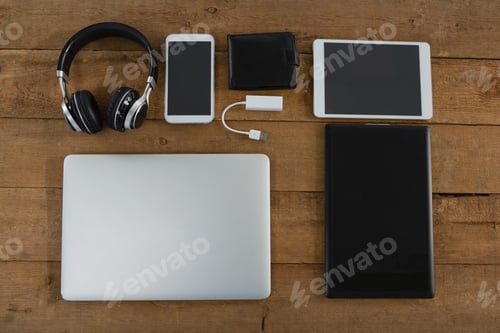 Preview: Overhead Of Various Electronic Gadgets On Wooden Plank