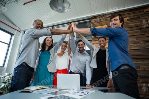 Preview: Team Of Graphic Designers Giving High Five To Each Other In Office
