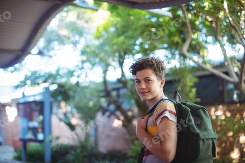 Preview: Portrait Of Happy Schoolboy Standing In School Campus