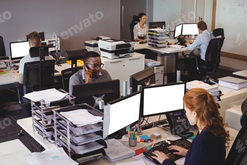 Preview: High Angle View Of Business People Working At Desk In Office