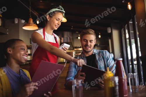 Preview: Beautiful Waitress Taking Order At Restaurant
