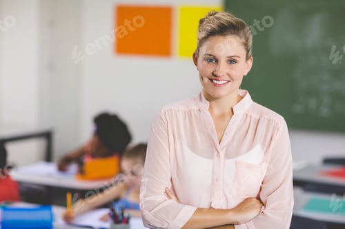 Preview: Portrait Of Teacher Standing With Arms Crossed In Classroom At School