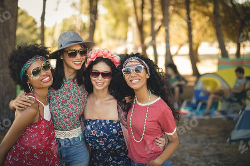 Vista previa: Portrait Of Smiling Female Friends Standing Together At Campsite